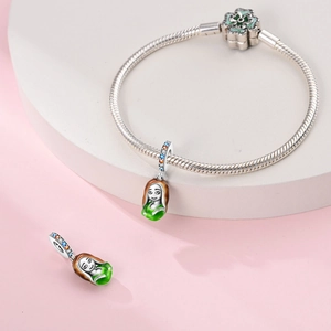 Close-up of Rapunzel enamel charm on silver snake chain bracelet with flower clasp