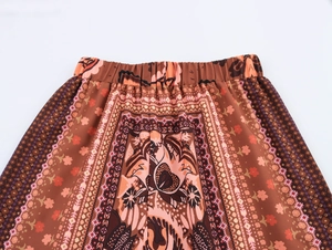 Detailed macro view of bohemian geometric floral print and elastic waistband on wide-leg pants