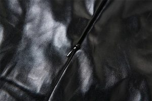 Close-up of invisible zipper detail on premium black PU leather dress with fine stitching