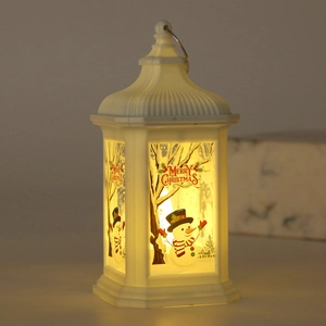 Detail of white Christmas LED lantern showing snowman patterns and warm glowing light