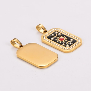 Gold stainless steel tarot pendant with black enamel sun moon and red gemstone