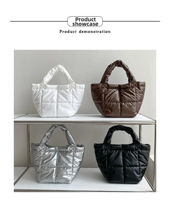 Quilted puffer handbags in white, brown, silver, and black shown on a display shelf