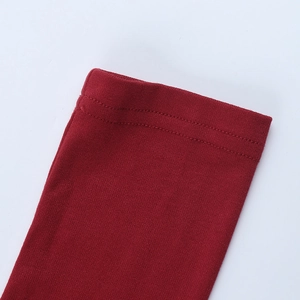 Close-up of burgundy red rose knit top showing detailed stitching and fabric texture