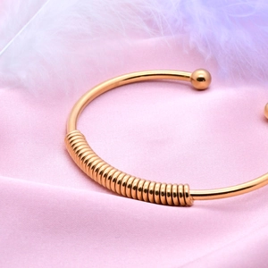 Minimalist gold stainless steel open spring bracelet with elegant ball end design
