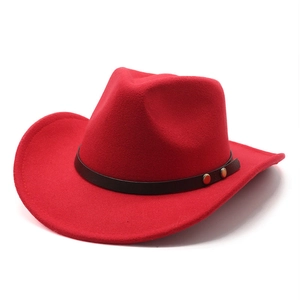 Detail of red wool felt western cowboy hat with black leather band and gold rivets