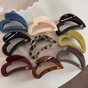 Elegant M-shaped heart hair claws in nine various colors with gold 'Love' metal detail