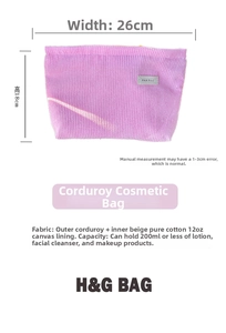 Detail view of purple corduroy makeup bag with 26x18cm size labels and canvas lining