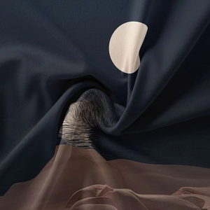 Detail of high-quality fabric showing a moon and wave pattern with silky texture folds