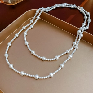 Top view of French vintage double layer pearl necklace on a gold tray for women