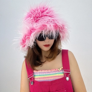 Detail of fluffy bright pink faux fur bucket hat showing soft long hair texture and style