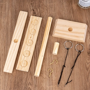 Handmade wooden ring toss game components made of pine wood on a dark table surface