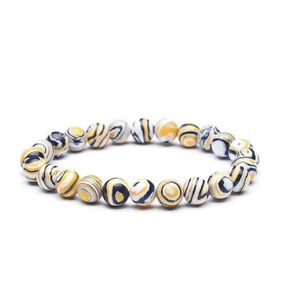 Detailed close-up of 8mm natural stone beads with yellow, black, and white textures