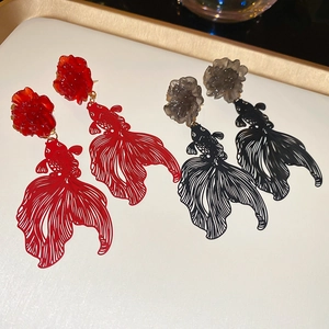 Detailed view of traditional Chinese style resin flower and hollow koi fish drop earrings