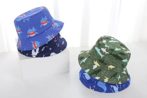 Detail of breathable cotton sun hats for kids featuring ocean shark and anchor patterns