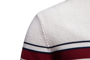 Macro view of shoulder seams and striped knit texture on men's color-block sweater