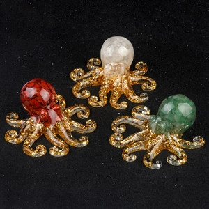 Three handmade crystal octopus figurines with gold foil and colorful resin stones