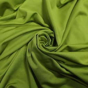 Close-up of olive green milk silk fabric texture with soft drape and subtle luster