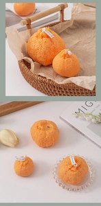 Vista detallada de velas aromáticas con forma de naranja y textura de piel realista
