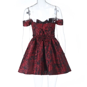 Close-up of off-shoulder mini dress with burgundy floral jacquard and back bow tie detail