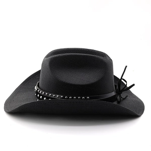 Detail of black straw cowboy hat with a studded leather band and curved wide brim