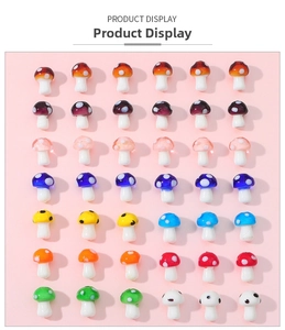 Macro view of assorted colorful handmade glass mushroom beads with white polka dots for DIY