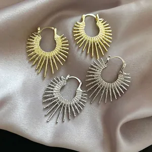 Irregular sunburst hoop earrings in gold and silver finish with twisted rope texture