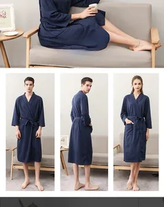 Detail of navy blue waffle robe fabric texture with adjustable waist tie and side pockets