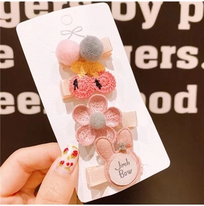 Detail of 4-piece cute pink hair clip set including cherry, flower, and bunny designs