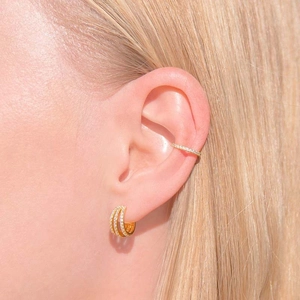 Elegant gold C-shaped earring set with full zircon inlay worn on a female model