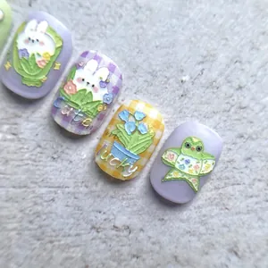 Macro view of 5D embossed nail stickers featuring cute rabbits and floral patterns