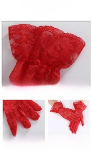 Close-up of red lace gloves showing intricate floral mesh and elastic scalloped cuffs