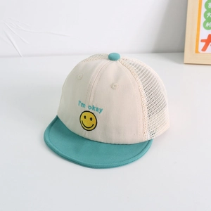 Detail of baby sun hat featuring embroidered smiley face and breathable mesh panels