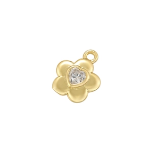 Detail of a golden five-petal flower pendant with a sparkling heart-shaped clear gemstone