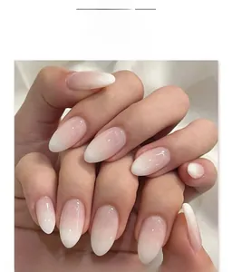 Detailed macro view of almond-shaped gradient pink and white press-on artificial nails