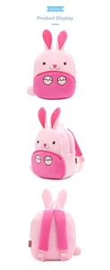 Front, side, and back views of a pink plush rabbit backpack with long ears and soft fur