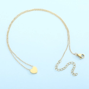 Close-up of golden heart pendant necklace with lobster clasp and adjustable chain