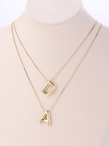 Detailed macro of 18K gold plated puffy balloon initial pendants D and A on box chains