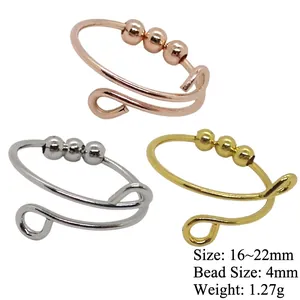 Three-piece fidget spinner ring set in gold, silver, and rose gold with movable beads