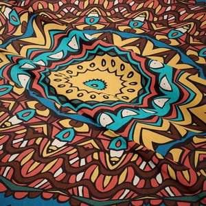Close-up detail of Bohemian mandala tapestry showing thick twill fabric texture and vivid patterns