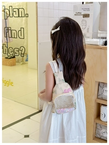 Close-up of floral child chest bag with transparent glitter PVC layer and adjustable strap