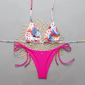 Detailed flat lay of printed halter bikini top and hot pink side-tie swim bottoms