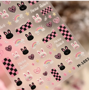 Detail showing bunny and checkered heart nail art stickers with embossed M-1057 design