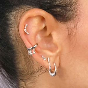 Silver geometric earrings set with clear zircon studs and ear cuffs on female model