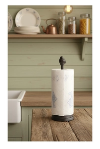 Dettaglio portarotolo in ghisa vintage con uccellino decorativo su base circolare