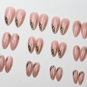 Almond-shaped leopard print press-on nails with golden wave lines on a nude base