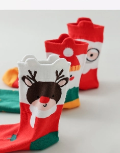 Detailed knit of Christmas socks featuring reindeer and Santa patterns in festive colors