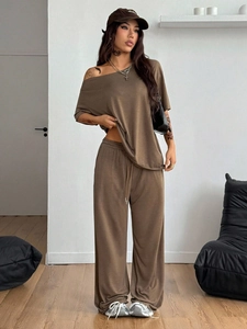 Detail of soft brown knitted loungewear set featuring oversized top and wide-leg pants