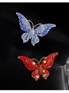 Detailed view of luxury crystal butterfly brooches in vibrant blue and red rhinestone