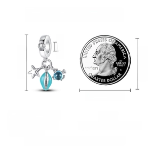 Detailed view of S925 silver ocean charm with starfish, shell, and size reference coin