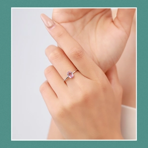 Elegant s925 silver ring featuring an oval purple gemstone shown worn on a finger